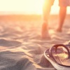 a man standing in the sand at the beach