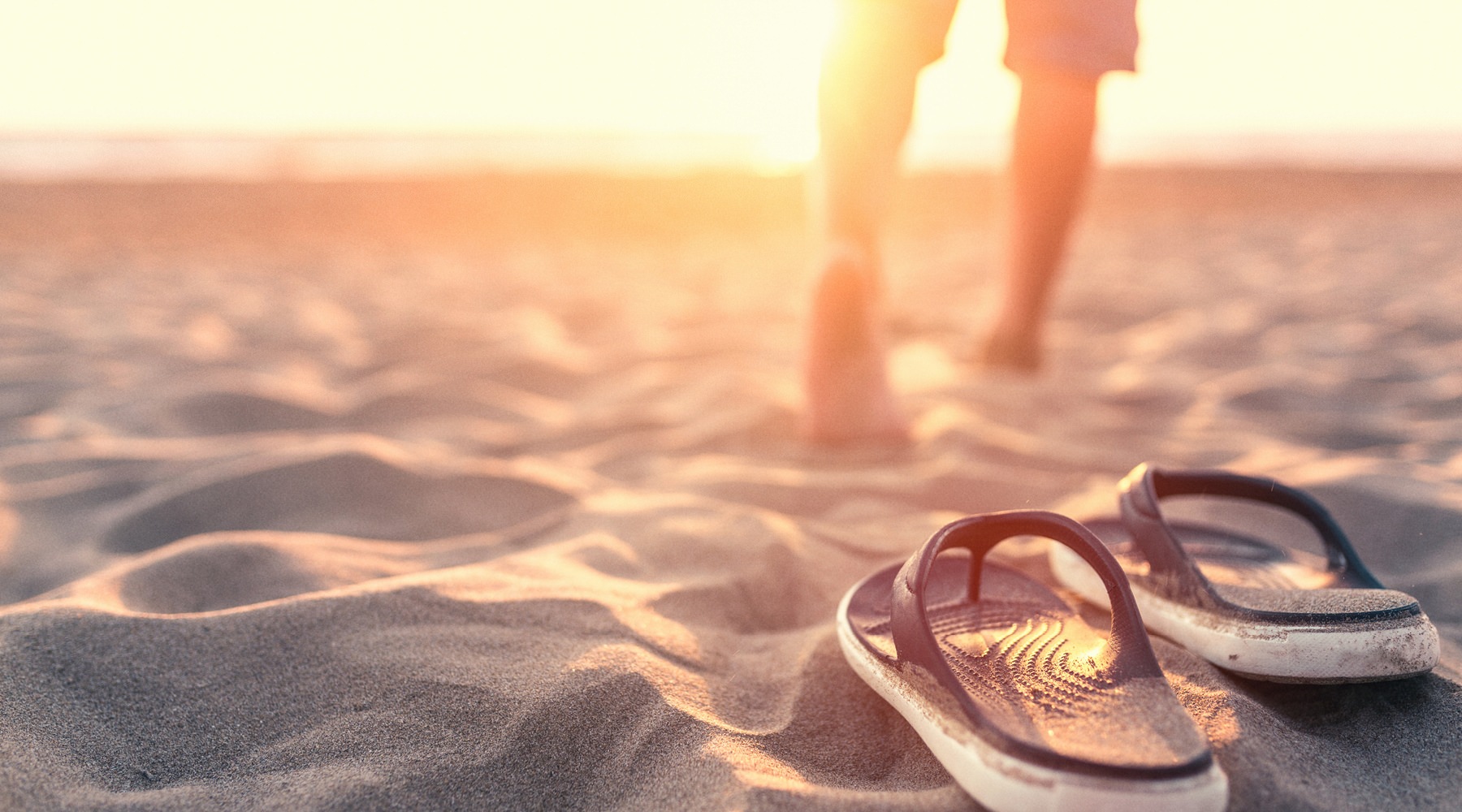 a man standing in the sand at the beach